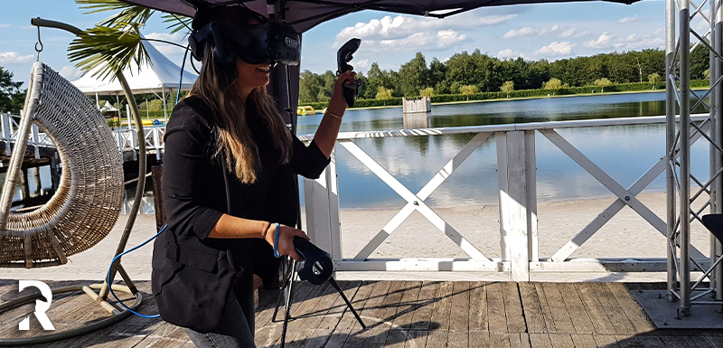 Woman playing VR at a lake
