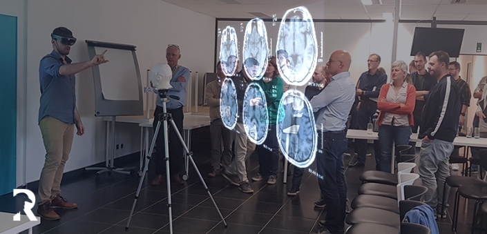 Professor demonstrating head scan using augmented reality